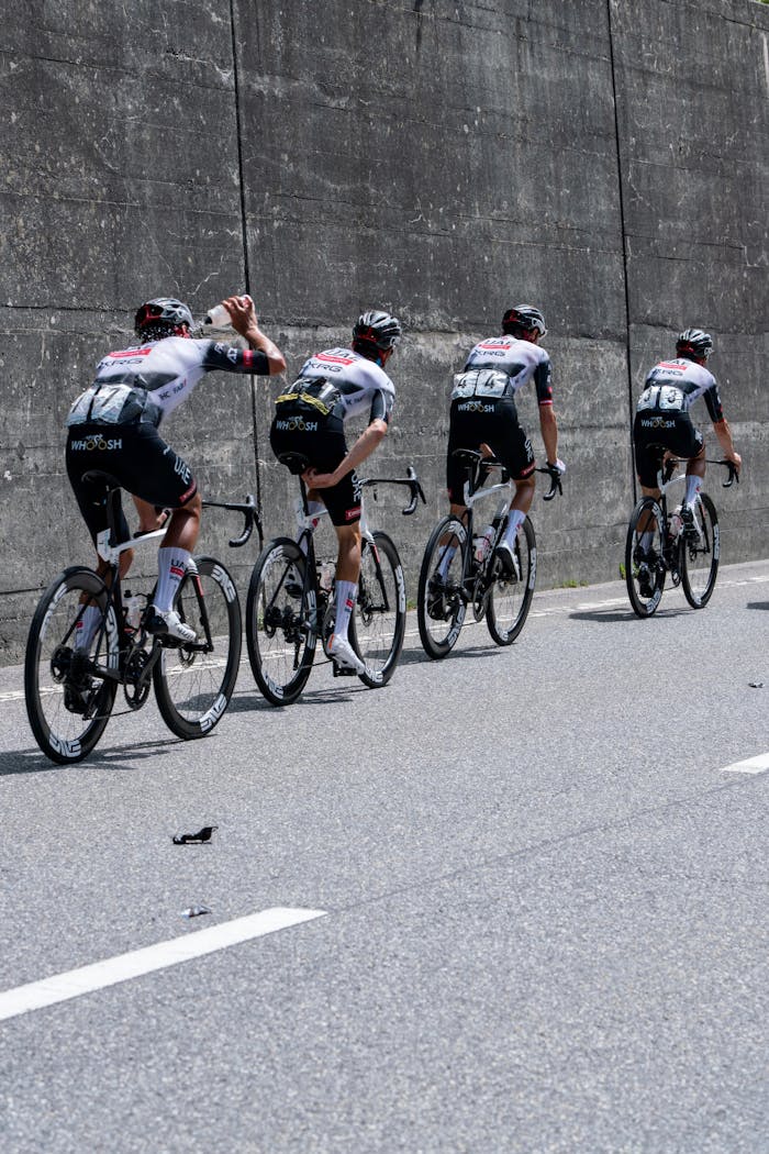 creative-02 Dynamic capture of a team of cyclists racing on a city road, showcasing teamwork and sport intensity.