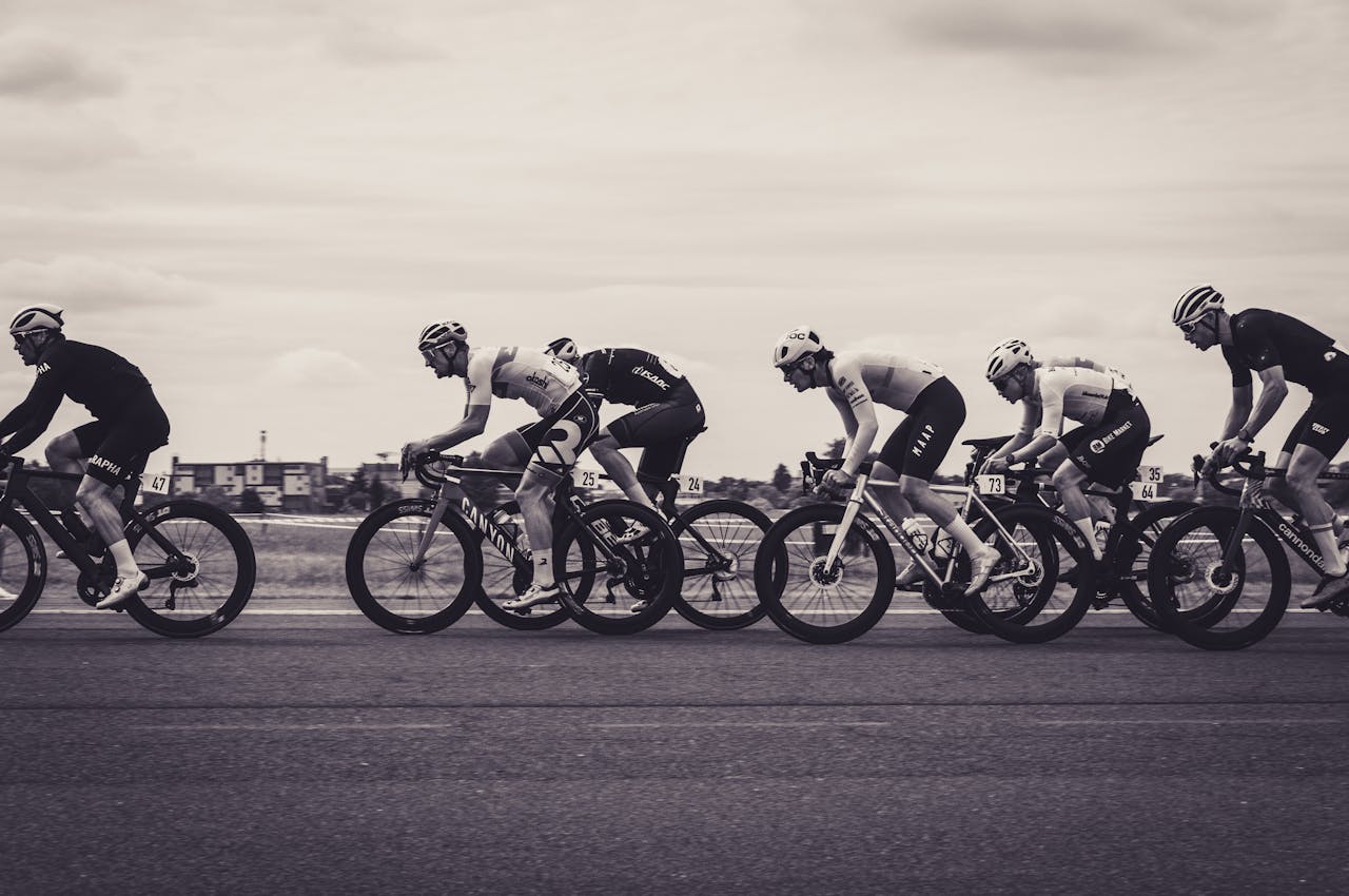 digital-01 Monochrome photograph of a fast-paced road cycling race with multiple cyclists in action.